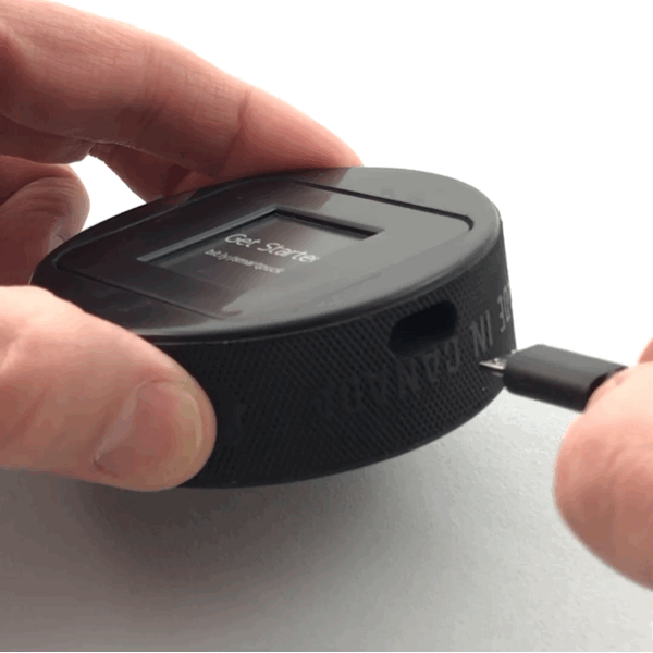 Plugging USB cable into puck